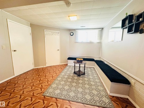 This room features light-colored walls, a drop ceiling, and two white doors - 15 Pinecliff Close Ne, Calgary, AB - Indoor Photo Showing Other Room