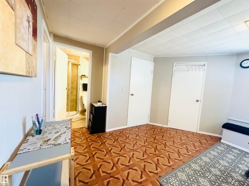 This area features durable patterned flooring and light-colored walls - 15 Pinecliff Close Ne, Calgary, AB - Indoor