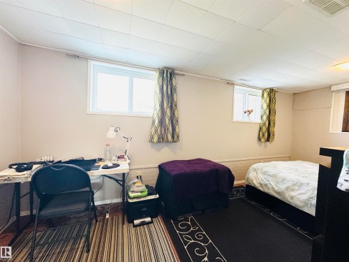This room features two windows providing natural light, light-colored walls, and a dropped ceiling - 15 Pinecliff Close Ne, Calgary, AB - Indoor Photo Showing Office
