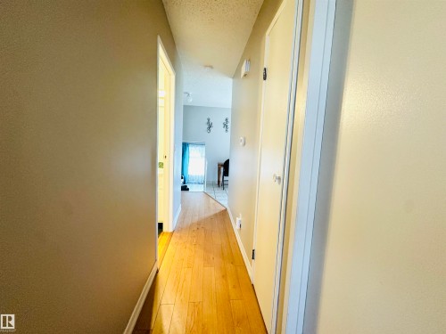 Hallway with hardwood floors and light-colored walls - 15 Pinecliff Close Ne, Calgary, AB - Indoor Photo Showing Other Room