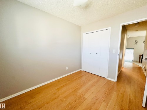 This room features light-colored walls and hardwood flooring - 15 Pinecliff Close Ne, Calgary, AB - Indoor Photo Showing Other Room