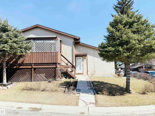 This property features a front yard with a lawn and mature trees - 15 Pinecliff Close Ne, Calgary, AB - Outdoor With Deck Patio Veranda