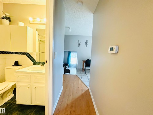 The property features a bathroom with a white vanity, a toilet, and wall-mounted storage cabinets - 15 Pinecliff Close Ne, Calgary, AB - Indoor Photo Showing Other Room