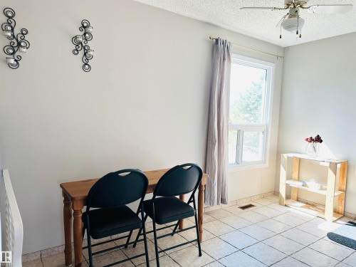 This space features tiled flooring and a window providing natural light - 15 Pinecliff Close Ne, Calgary, AB - Indoor Photo Showing Other Room