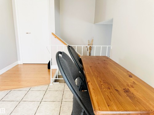 The property features a combination of tile flooring and light-toned wood flooring - 15 Pinecliff Close Ne, Calgary, AB - Indoor Photo Showing Other Room