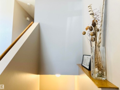 Stairwell with a wooden handrail and a recessed light illuminating the wall - 15 Pinecliff Close Ne, Calgary, AB - Indoor Photo Showing Other Room