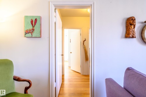 The property features white walls and hardwood flooring, creating a bright and inviting atmosphere - 12 6805 112 Street, Edmonton, AB - Indoor