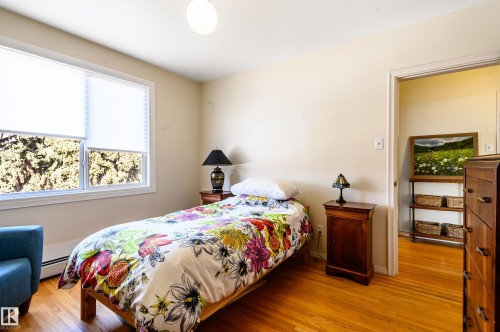 Bedroom featuring hardwood floors and a window with blinds - 12 6805 112 Street, Edmonton, AB - Indoor Photo Showing Bedroom