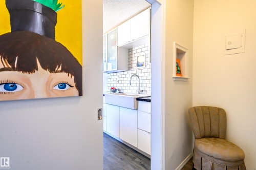 Kitchen featuring white subway tile backsplash, a farmhouse-style sink, and white cabinetry - 12 6805 112 Street, Edmonton, AB - Indoor Photo Showing Other Room