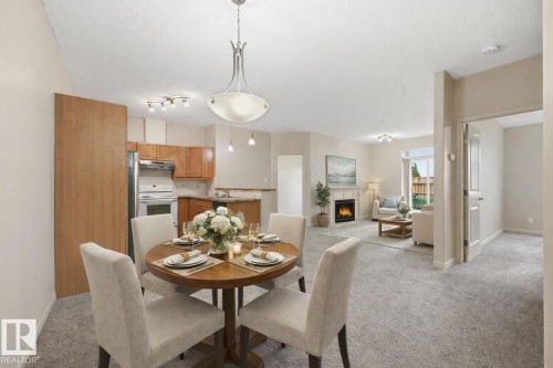 Virtually Staged - 139 2503 Hanna Crescent, Edmonton, AB - Indoor Photo Showing Dining Room With Fireplace