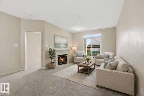Virtually Staged - 139 2503 Hanna Crescent, Edmonton, AB - Indoor Photo Showing Living Room With Fireplace