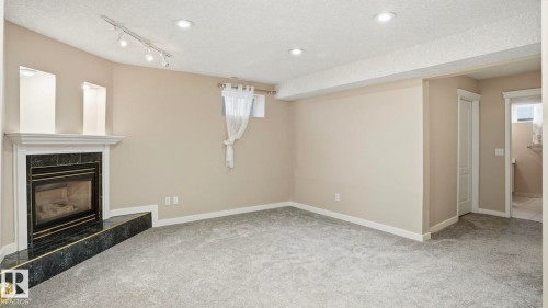 1007 Ormsby Crescent, Edmonton, AB - Indoor Photo Showing Other Room With Fireplace