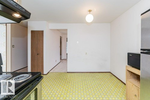 The kitchen area features a ceiling light fixture and patterned flooring - 8804 19 Avenue, Edmonton, AB - Indoor