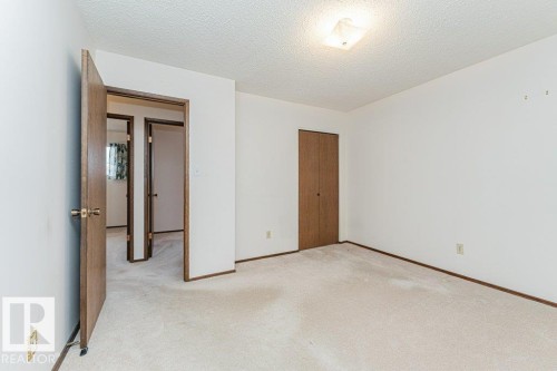This room features light-colored carpeting, white walls, and a ceiling light fixture - 8804 19 Avenue, Edmonton, AB - Indoor Photo Showing Other Room