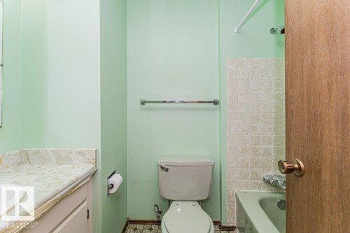 The bathroom features a vanity with a white sink and a patterned countertop - 8804 19 Avenue, Edmonton, AB - Indoor Photo Showing Bathroom