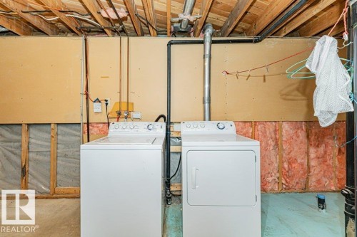 This utility space features a white washing machine and a white clothes dryer - 8804 19 Avenue, Edmonton, AB - Indoor Photo Showing Laundry Room