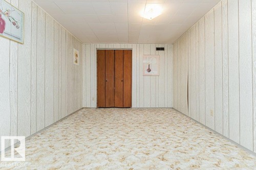 This room features light-colored paneled walls and a ceiling with a flush-mount light fixture - 8804 19 Avenue, Edmonton, AB - Indoor Photo Showing Other Room