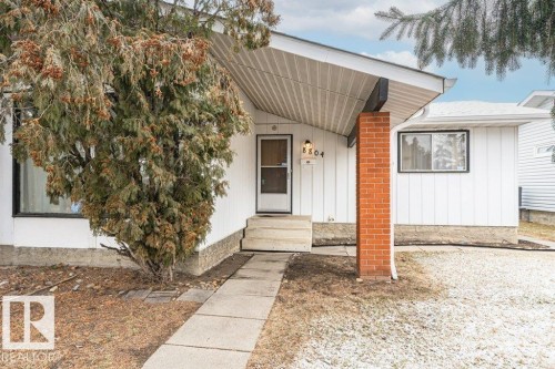 The property features a white exterior with vertical siding and a visible address number - 8804 19 Avenue, Edmonton, AB - Outdoor