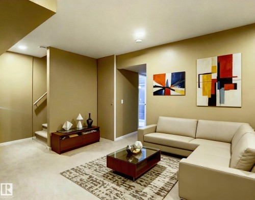 Living room featuring carpeting, recessed lighting, and a partial wall separating areas - 225 51A Street, Edmonton, AB - Indoor
