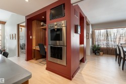 The property features light-colored flooring, a built-in oven, and a dedicated desk area - 