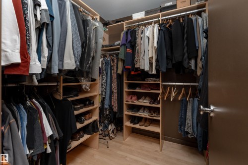 Custom closet system featuring hanging rods, shelving, and shoe storage - 9715 141 Street Nw, Edmonton, AB - Indoor With Storage