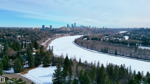 This aerial view showcases the surrounding community with a prominent skyline visible in the distance - 9715 141 Street Nw, Edmonton, AB - Outdoor With View