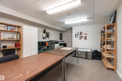 This versatile room features a drop ceiling, ample overhead lighting, and durable carpeting - 9715 141 Street Nw, Edmonton, AB - Indoor