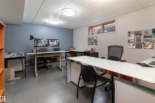 The property features a versatile room with a drop ceiling, recessed lighting, and grey flooring - 9715 141 Street Nw, Edmonton, AB - Indoor Photo Showing Office