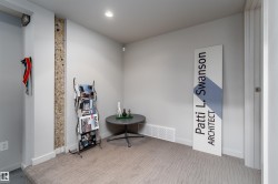 The room features light gray walls, a carpeted floor with a subtle pattern, and a recessed ceiling light - 