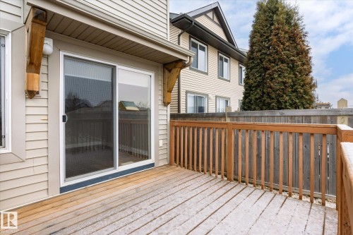 The property features a wooden deck with a wooden railing and sliding glass doors - 1668 Chapman Way, Edmonton, AB - Outdoor With Deck Patio Veranda With Exterior