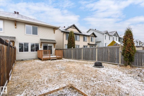 The property features a fenced backyard with a wooden deck and a fire pit - 1668 Chapman Way, Edmonton, AB - Outdoor