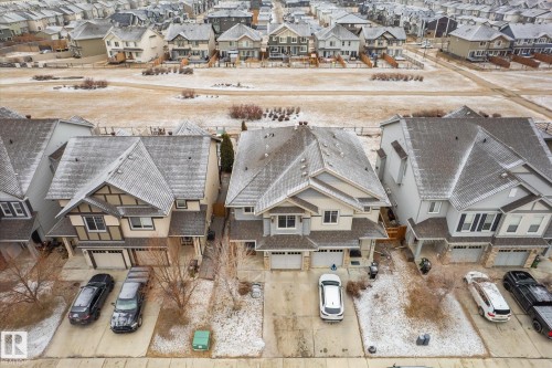 Aerial view of the neighborhood showcasing several properties with light-colored siding and snow-dusted roofs - 1668 Chapman Way, Edmonton, AB - Outdoor With Facade