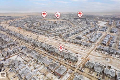 Aerial view of a residential area featuring numerous properties with snow-dusted roofs and streets - 1668 Chapman Way, Edmonton, AB - Outdoor With View