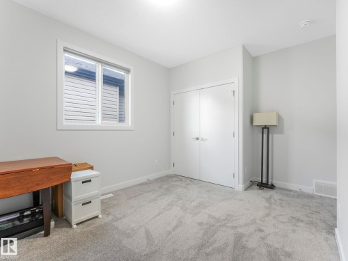 This room features light grey carpeting, white walls, and a window with white trim - 1104 152 Avenue, Edmonton, AB - Indoor Photo Showing Other Room