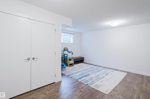This room features light-colored walls, recessed lighting, and wood-style flooring - 9612 72 Avenue, Edmonton, AB - Indoor Photo Showing Other Room