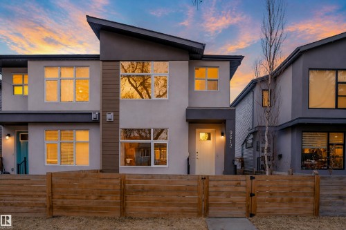 Contemporary facade featuring a light-colored exterior with dark trim and a prominent angular roofline - 9612 72 Avenue, Edmonton, AB - Outdoor