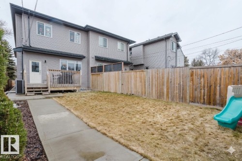 The property includes a wooden deck with railing, a concrete pathway, and a fenced yard - 9612 72 Avenue, Edmonton, AB - Outdoor With Deck Patio Veranda