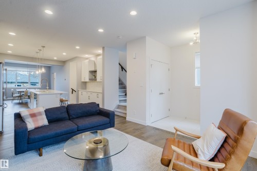 Living area featuring hardwood flooring, recessed lighting, and a white area rug - 9612 72 Avenue, Edmonton, AB - Indoor Photo Showing Living Room