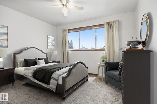 This room features a ceiling fan, a window with curtains, and light-colored walls - 9131 74 Street, Edmonton, AB - Indoor Photo Showing Bedroom