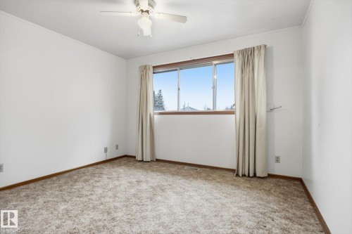 This room features a window providing natural light, a ceiling fan, and carpeted flooring - 9131 74 Street, Edmonton, AB - Indoor Photo Showing Other Room