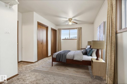 The property features neutral-toned walls, a window with curtains, and a ceiling fan - 9131 74 Street, Edmonton, AB - Indoor Photo Showing Bedroom