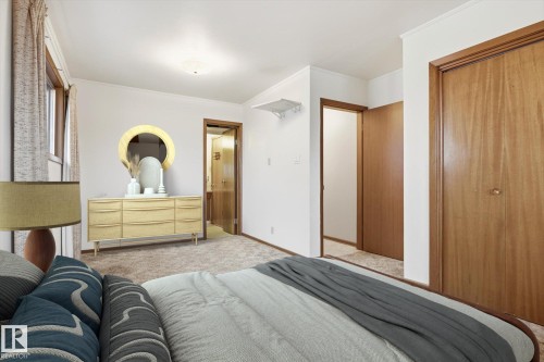 This room features carpeting, light-colored walls, and windows with drapes - 9131 74 Street, Edmonton, AB - Indoor Photo Showing Bedroom
