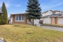 The property features a front yard with a lawn, a mature evergreen tree, and an established driveway - 9131 74 Street, Edmonton, AB  - Outdoor 