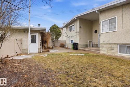 The property features a stucco exterior with stone accents and a well-maintained lawn - 9131 74 Street, Edmonton, AB - Outdoor With Exterior