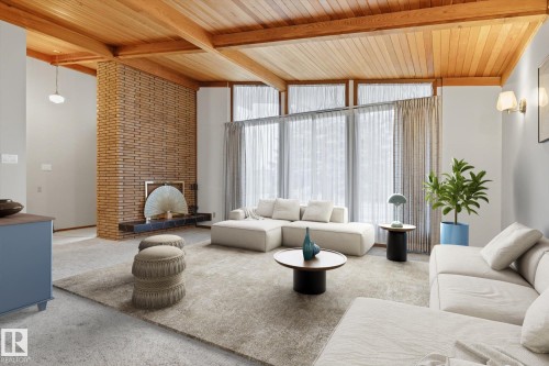 Living area featuring a brick accent wall, wood-paneled ceiling with exposed beams, and expansive windows - 9131 74 Street, Edmonton, AB - Indoor Photo Showing Living Room