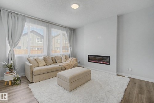 2721 Donaghey Crescent, Edmonton, AB - Indoor Photo Showing Living Room With Fireplace