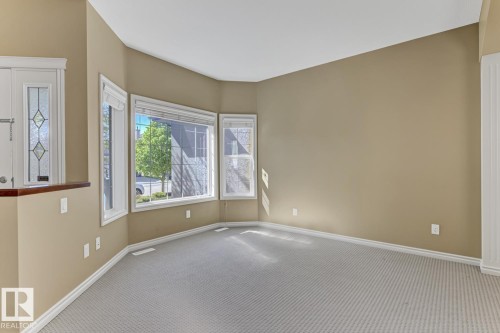 This inviting space features a bay window, offering natural light - 3105 Tredger Place, Edmonton, AB - Indoor Photo Showing Other Room