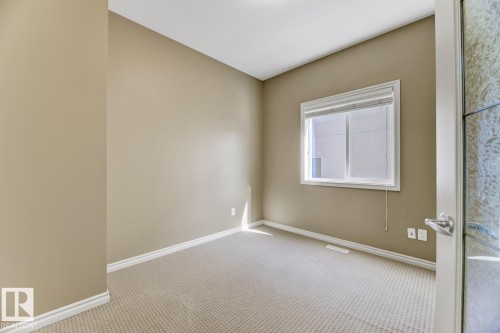 This room features neutral-toned walls, a window with blinds, and light-colored carpet - 3105 Tredger Place, Edmonton, AB - Indoor Photo Showing Other Room