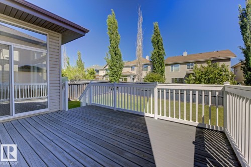 The property features a spacious outdoor deck with wood flooring and white railings, offering ample room for outdoor enjoyment - 3105 Tredger Place, Edmonton, AB - Outdoor With Deck Patio Veranda With Exterior