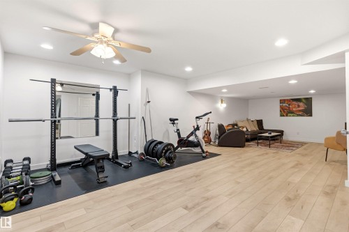 Spacious room featuring light-toned flooring, white walls, and recessed lighting - 18315 68 Avenue, Edmonton, AB - Indoor Photo Showing Gym Room